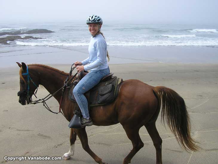 girl oriding on horse on beach in california