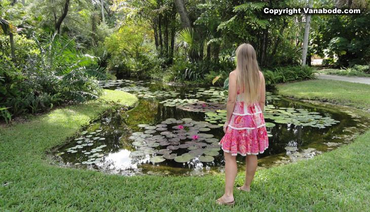 girl at waterlily pond in mckees gardens