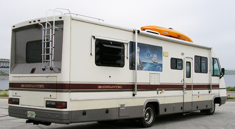 class a rv with kayak on roof