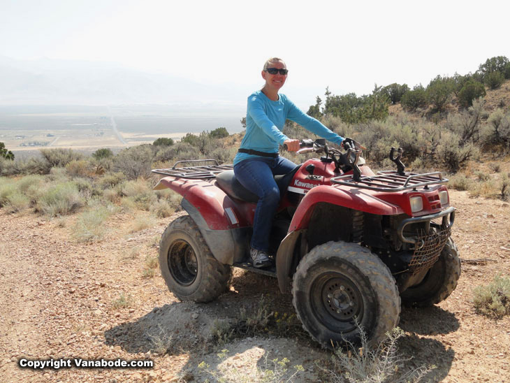 pretty blonde riding offroad in the desert on an atv